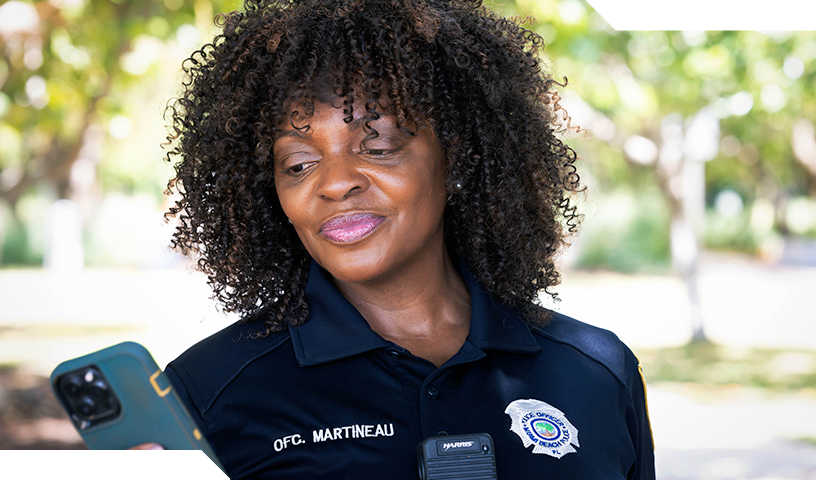 Neighborhood resource officer looking at mobile phone