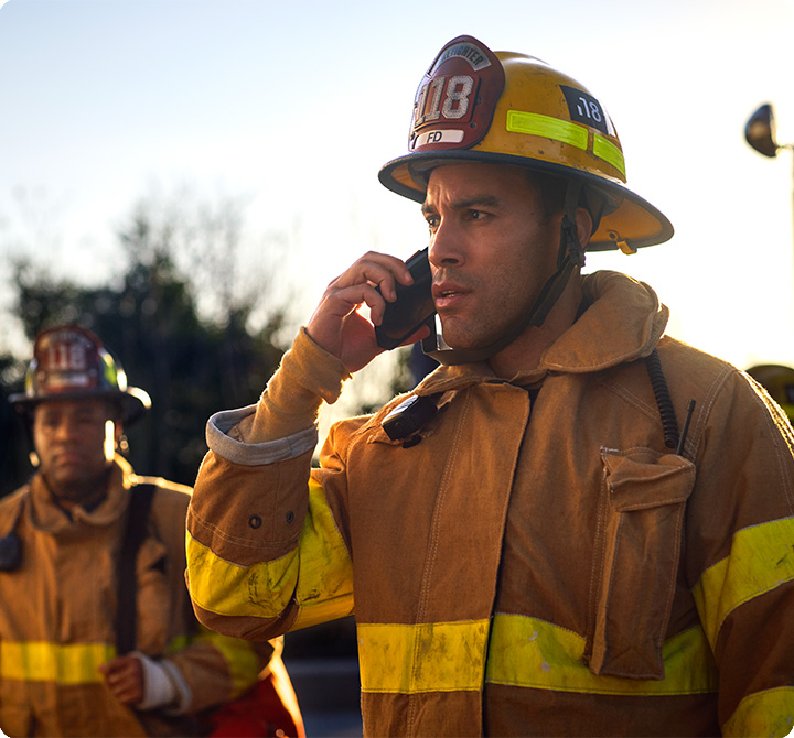 Firefighter using smart phone on the scenet