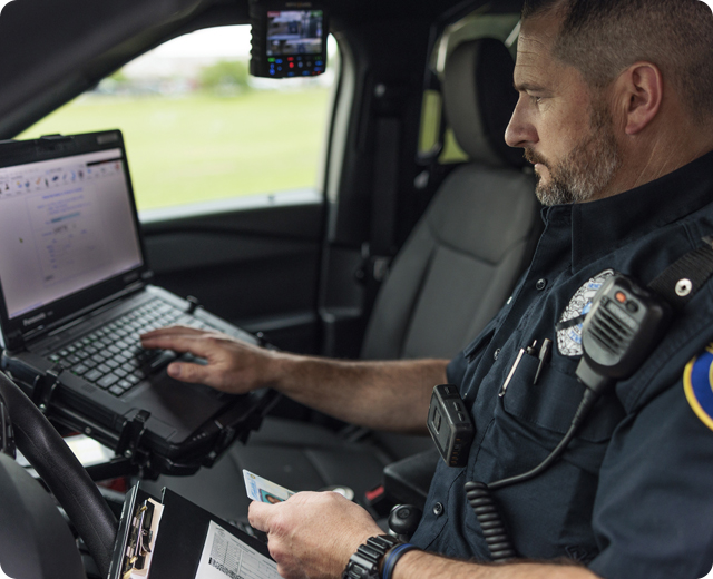 Hendersonville police department officer using laptop in police car