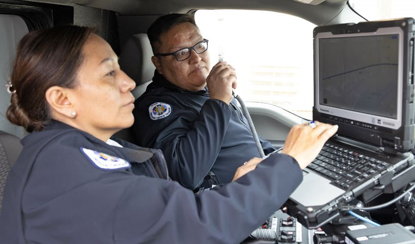 Navajo nation emergency med techs using CB and laptop in a vehicle